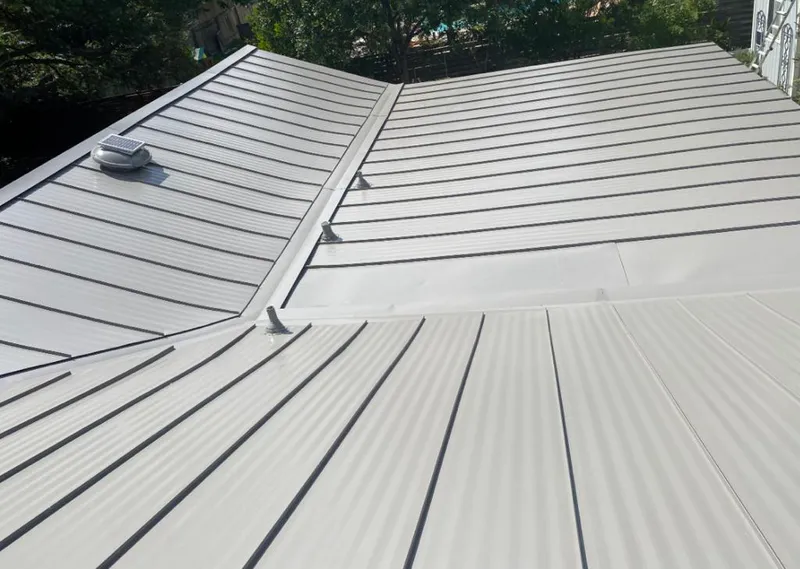 Solar attic fan installed on a metal roof for Roof Ventilation in Rochelle Park
